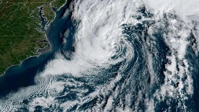 Satellite view of a large swirling storm system spinning over the Atlantic Ocean off the eastern United States
