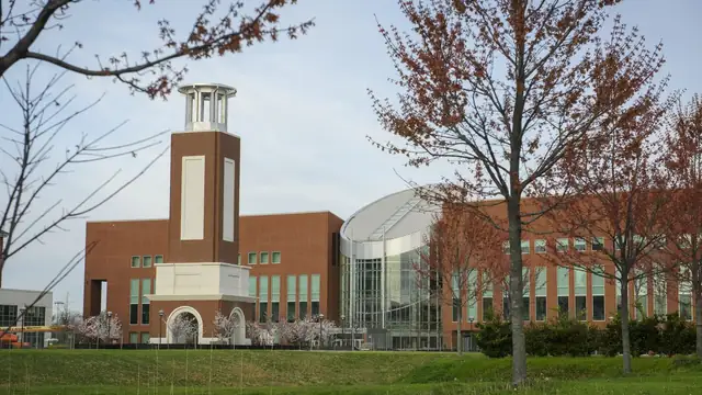 The brick tower of the Lyman Beecher Brooks Library at Norfolk State University behind a lawn and bare fall trees