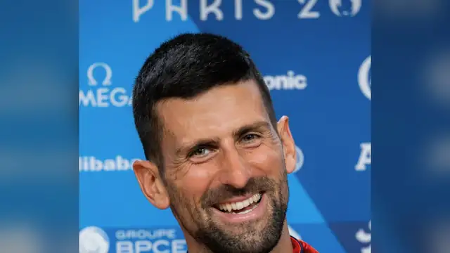 Novak Djokovic smiling at a Paris 2024 Olympics press event