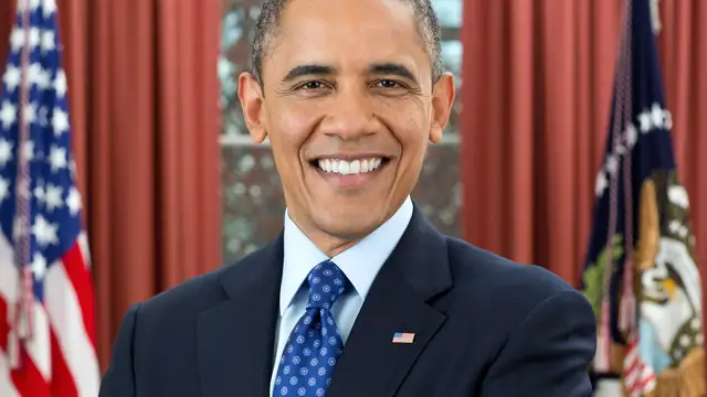 Official portrait of former President Barack Obama smiling with arms crossed in the Oval Office