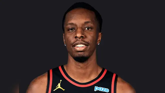 Onyeka Okongwu smiling in a black Atlanta Hawks jersey
