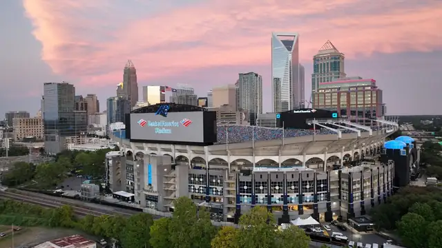 Bank of America Stadium sits in front of the Charlotte skyline at sunset
