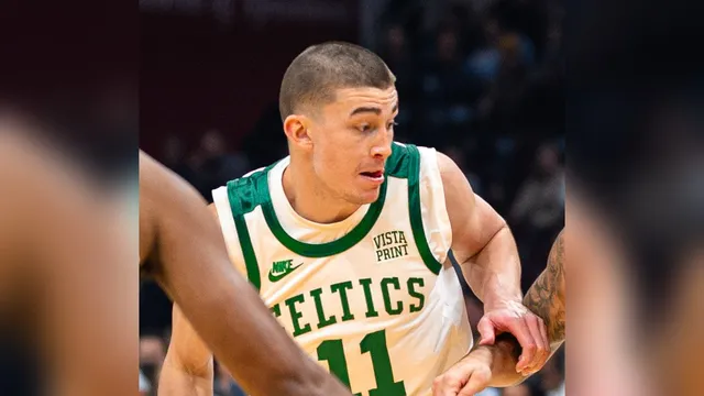 Payton Pritchard in a white Celtics No. 11 jersey drives with the ball during a game