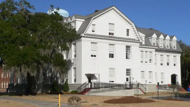 Hill Hall, a white three-story building on the Savannah State University campus beside live oak trees draped in Spanish moss