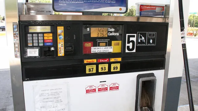 A pay-at-the-pump gasoline dispenser with digital price displays and fuel grade buttons at a U.S. filling station