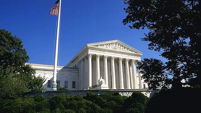 Front portico and columns of the U.S. Supreme Court building under a clear sky