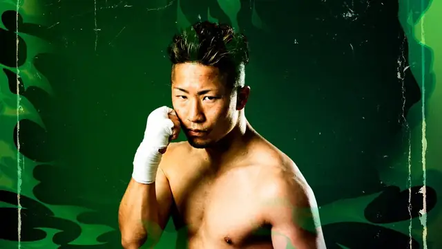 Takuma Inoue in a fighting stance with his gloves up against a green background