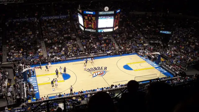 An Oklahoma City Thunder home game in progress seen from the upper deck with the Thunder logo at center court