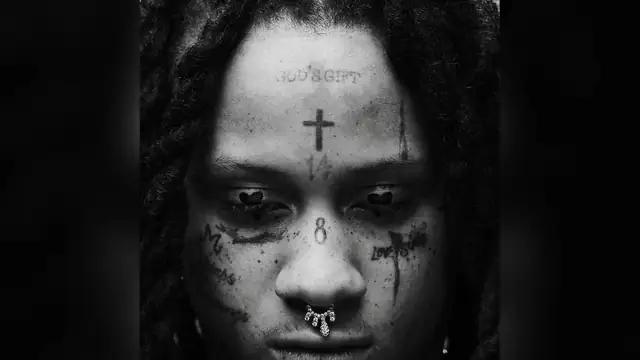 Black and white close portrait of Trippie Redd with face tattoos