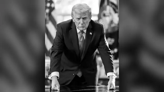 Donald Trump leaning on the Resolute Desk