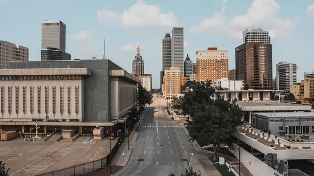 Downtown Tulsa skyline with high-rise towers rising above an empty street on a clear day