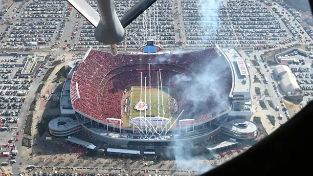 A KC-135 refueling boom hangs over an aerial view of Arrowhead Stadium in Kansas City packed with fans in red during a January 2023 Chiefs game