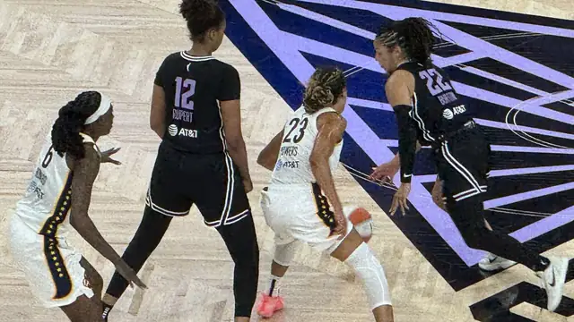Golden State Valkyries guards Veronica Burton (No. 22) and Iliana Rupert (No. 12) in black uniforms defending Indiana Fever players at Chase Center in August 2025