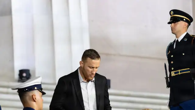 UFC lightweight champion Justin Gaethje in a black shirt descends the Lincoln Memorial steps during a press event