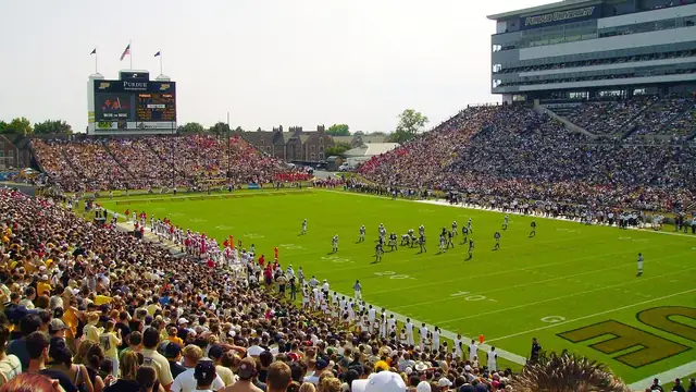 Fans in gold and black fill the stands at Ross-Ade Stadium in West Lafayette, Indiana as a Purdue football game plays out on the field