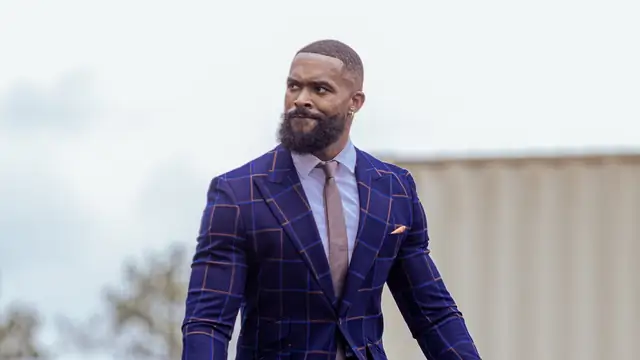 Montez Ford in a blue plaid suit and tie outdoors at an Army birthday celebration