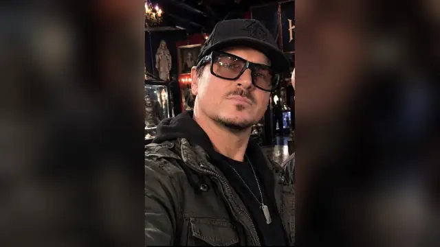 Zak Bagans in a black cap and glasses inside his Las Vegas Haunted Museum