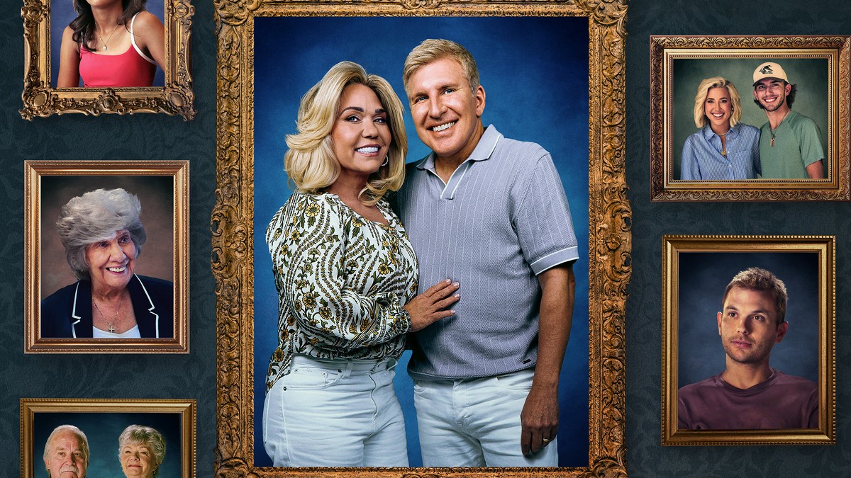 Todd and Julie Chrisley smiling in a gold picture frame surrounded by framed family portraits