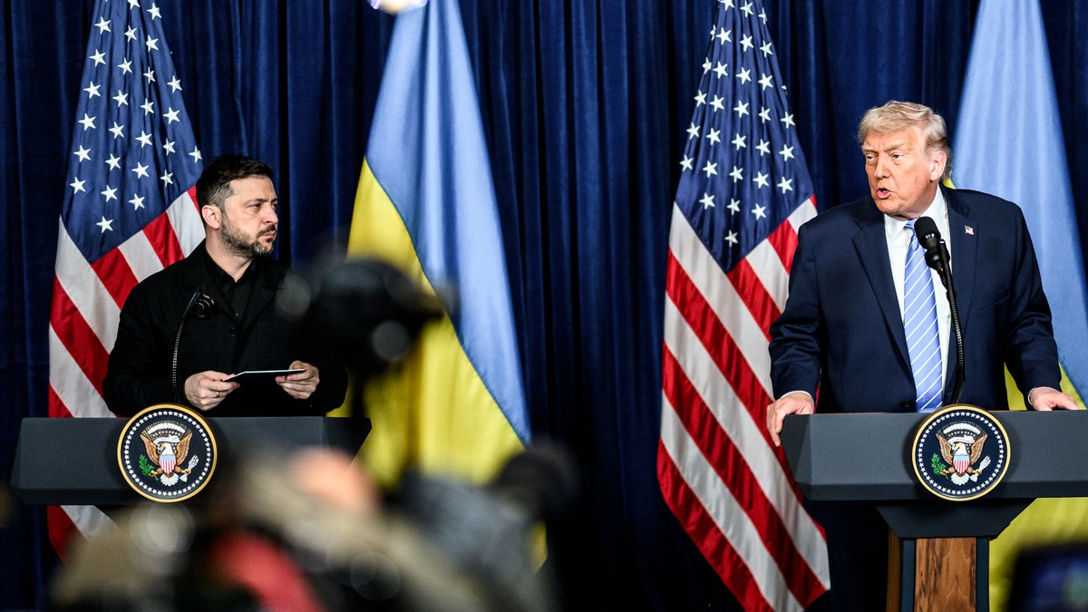 Donald Trump speaking at a podium as Volodymyr Zelensky listens at a joint press conference