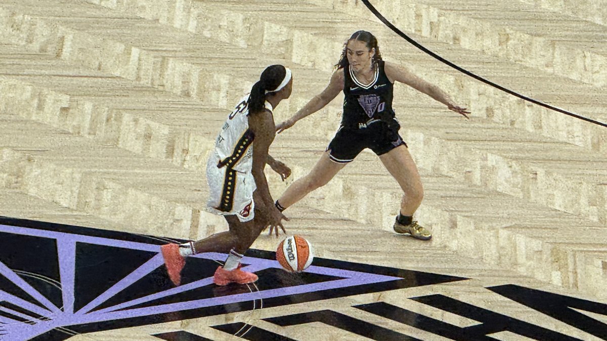 A Golden State Valkyries guard in a black uniform defending an Indiana Fever ball handler on the court at Chase Center