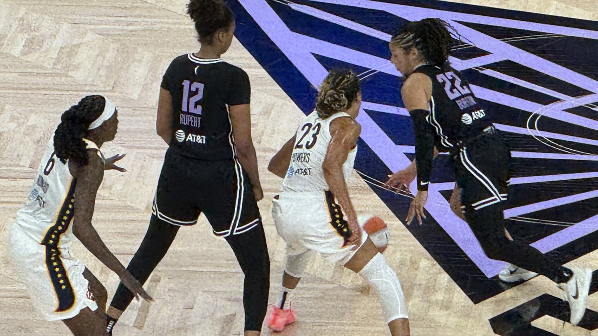Golden State Valkyries guards Veronica Burton (No. 22) and Iliana Rupert (No. 12) in black uniforms defending Indiana Fever players at Chase Center in August 2025