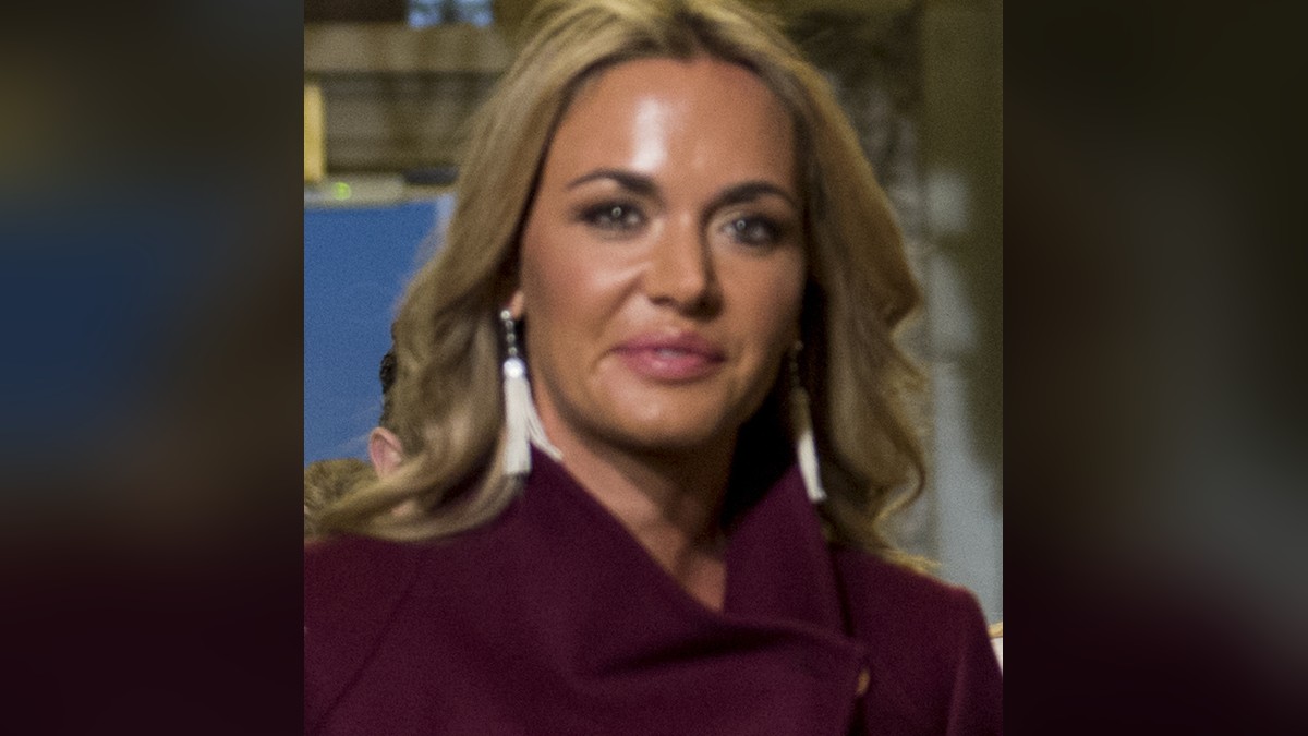 Vanessa Trump with long blonde hair in a burgundy coat