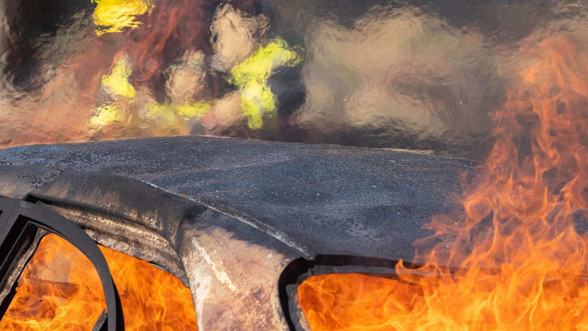 A car engulfed in flames during a firefighter training exercise