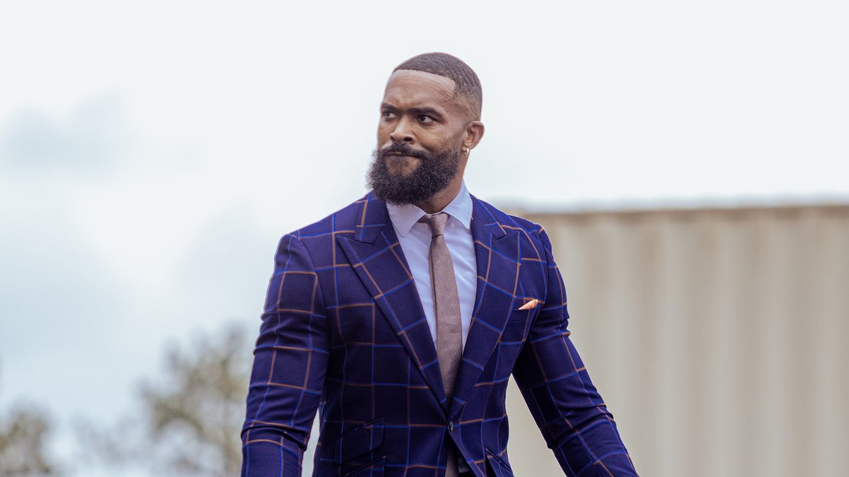 Montez Ford in a blue plaid suit and tie outdoors at an Army birthday celebration